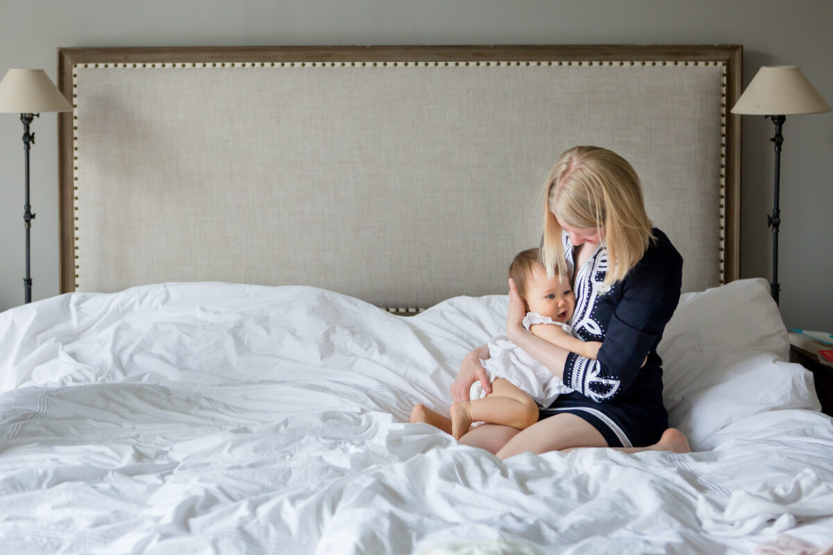 mom and toddler share a quiet embrace on mom's bed