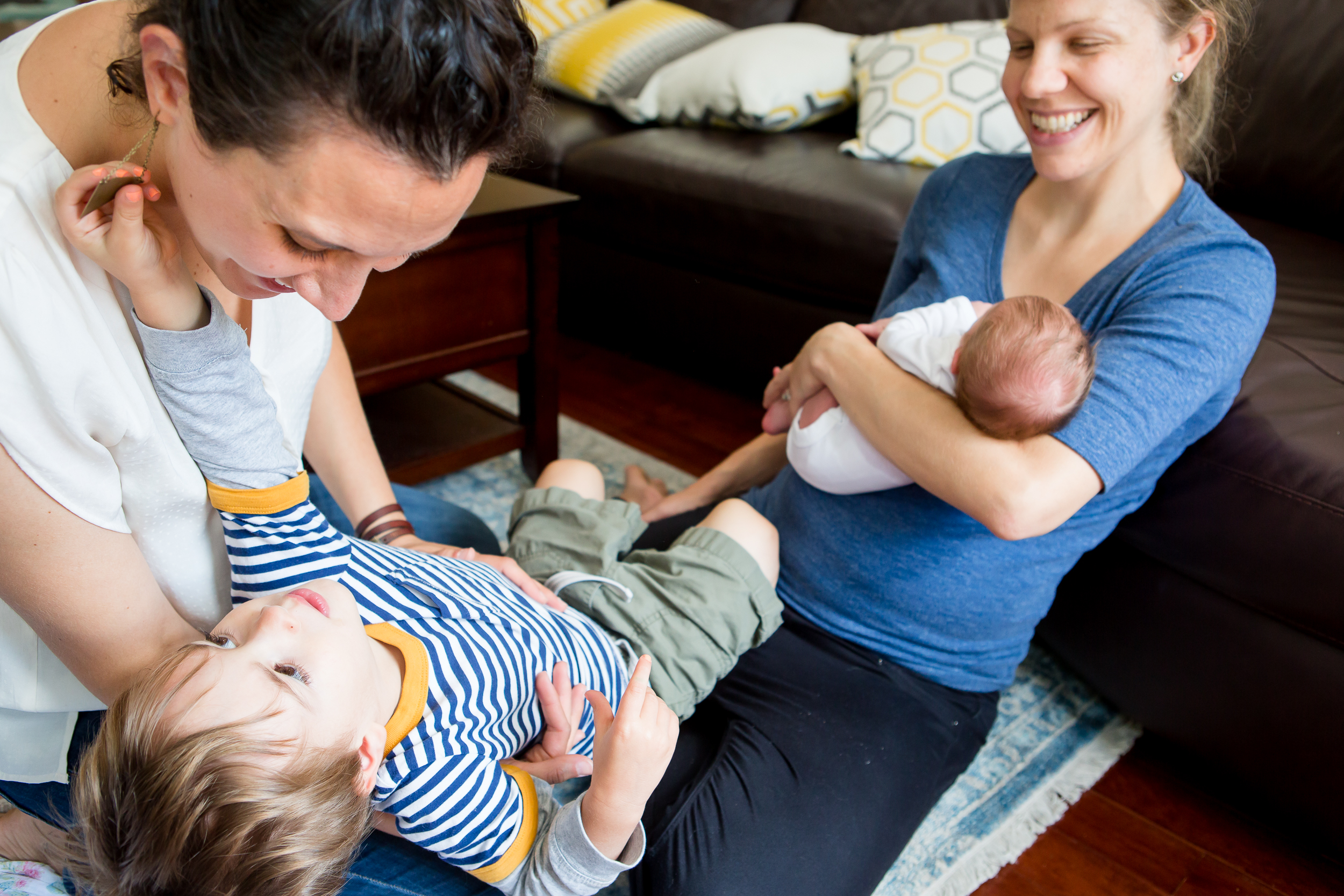 two moms play with their kids during a somerville family photography session