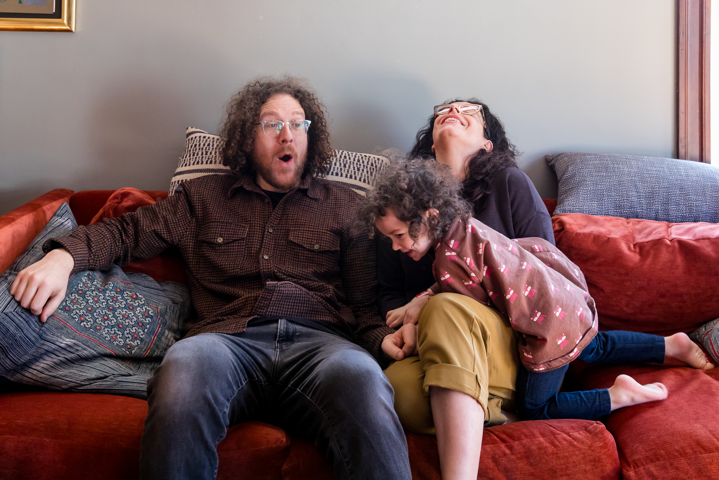 Genuinely joyful family moment, proof a kid doesn't have to fake a smile for family photos to be beautiful